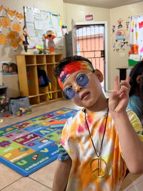 A boy on the alphabet rug in the learning corner